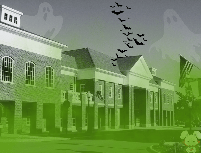 Black and white photo of the front of the Hudson Library with green smog on top and graphics of 2 ghosts, bats and a vampire bunny. 