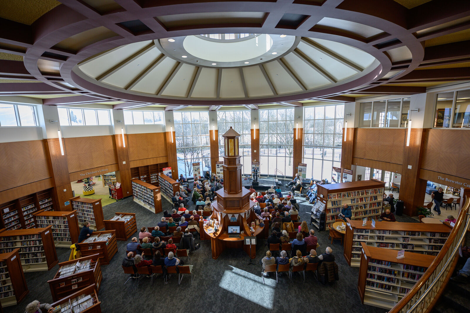 Library rotunda filled with people seated watching a concert.