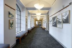 Art gallery hallway, art hung on both sides.