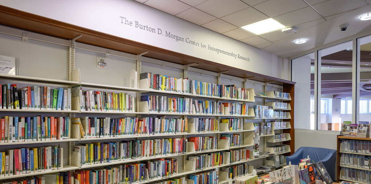 Bookshelves filled with books, overhead reads 