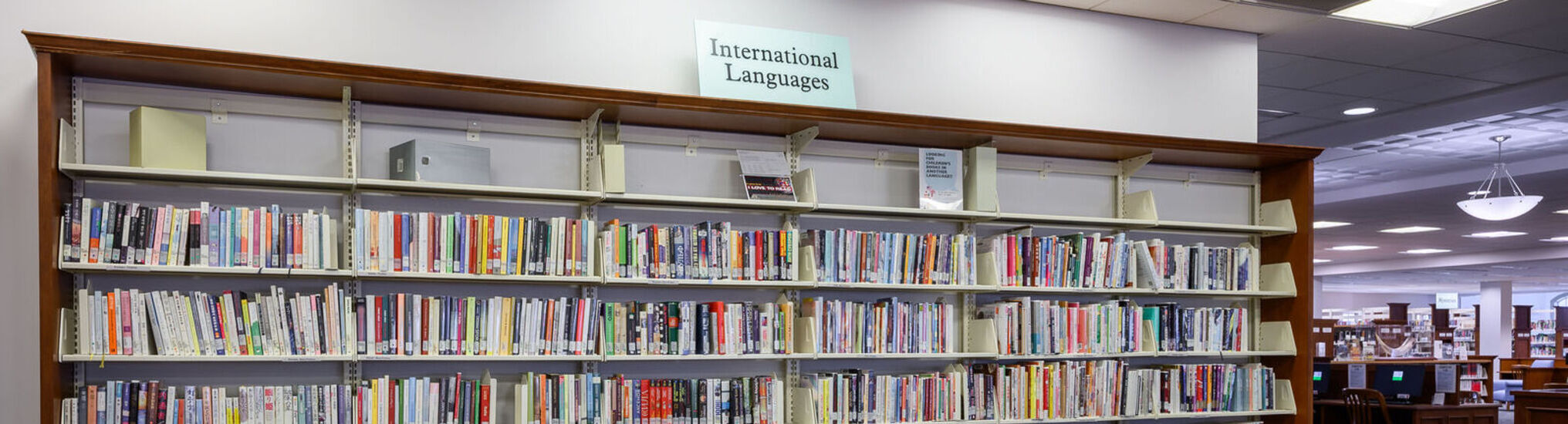 Bookshelves with sign at top that reads, 