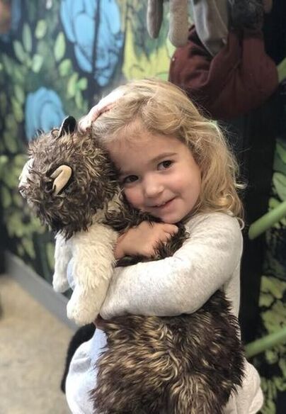 Little girl hugging stuffed animal