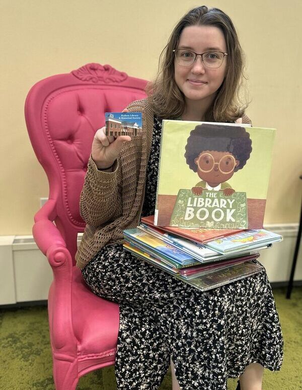 patron holding up library card